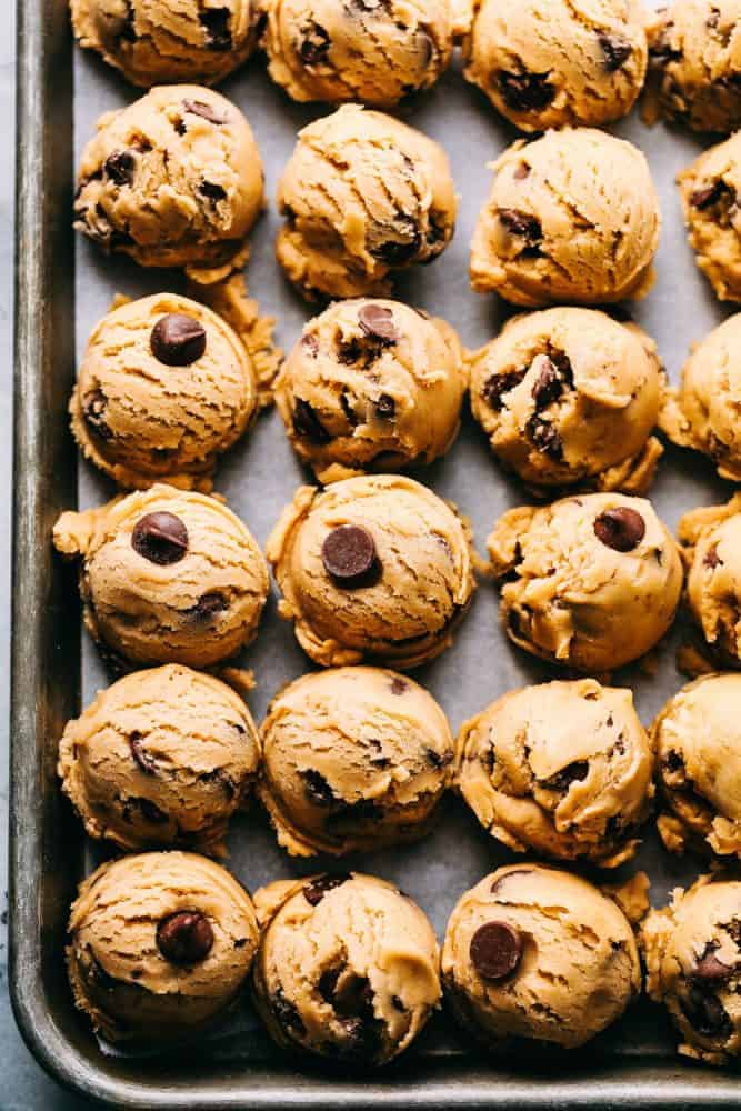 The Best Chocolate Chip Cookies turn out perfect every single time and don't require any chilling time. This is a classic tried and true chocolate chip cookie recipe that you will make again and again! Cookie dough in rows on a baking sheet.