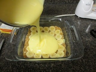 It's nice and cool and hits the spot! For all of the banana cream pie lovers out there, this is the dessert for you! Cream being poured over the sliced bananas and Nilla Wafer base.
