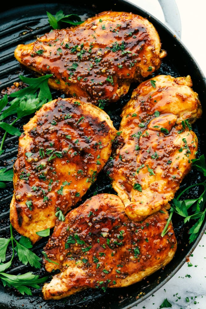 Grilled Honey Mustard chicken is tender and juicy grilled chicken covered in a sweet and tangy sauce with a punch of spice. It is simple to prepare and so flavorful. The fresh and perfectly balanced flavors of the honey mustard will be a staple in your summer BBQ plans! Grilled honey mustard chicken on grill.