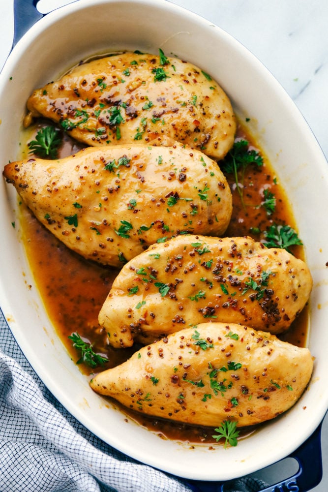 Honey Butter Baked Chicken is a rich and flavorful dinner that has tender baked chicken made with only four ingredients! The blend of honey and butter is the perfect combination for a flavorful chicken dinner.ย Honey butter baked chicken in a pan ready to be baked.
