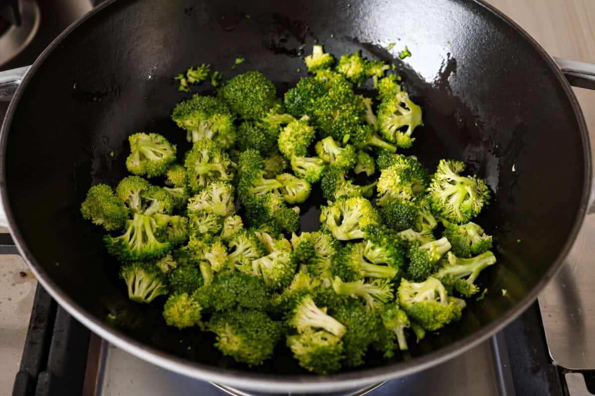 This Mongolian beef and broccoli recipe is the best P.F. Chang’s copycat recipe. You will love the combination of tender beef, vibrant broccoli and intensely flavorful sauce. Save yourself money while making your family happy with this quick and easy recipe. Overhead shot of broccoli sautéing in a skillet.