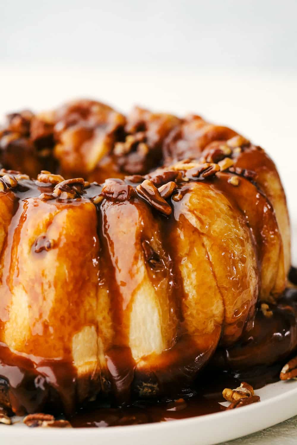 Sticky Buns are the most gooey, caramel infused, morsels of breakfast yumminess EVER! Super simple and quick to throw together these are going to become a go to for your holiday breakfasts. Sticky buns with caramel sauce ready to eat.