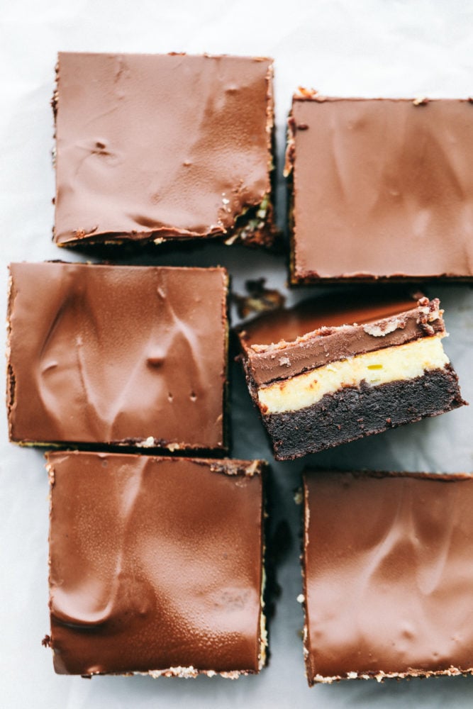 This delicious Hershey's chocolate cheesecake brownies are layered with a moist, homemade chocolate cake with a creamy cheesecake filling topped with a thick Hershey chocolate layer making this irresistible. Heaven on a plate! A top photo of the Hershey chocolate cheesecake brownies cut into squares.