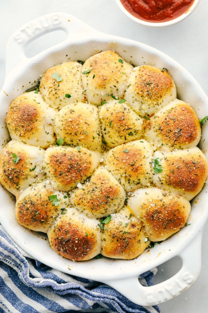 These pizza bites taste just like pizza using a flattened biscuit and stuffing it full of cheese, pepperoni then baking until golden brown on top. Stuffed pizza bites are the hit of our house! Skillet full of stuffed pizza bites.