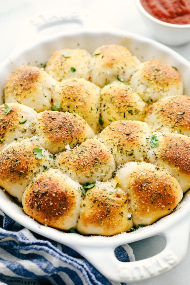 These pizza bites taste just like pizza using a flattened biscuit and stuffing it full of cheese, pepperoni then baking until golden brown on top. Stuffed pizza bites are the hit of our house! Pizza bites baked with parsley on top of it.
