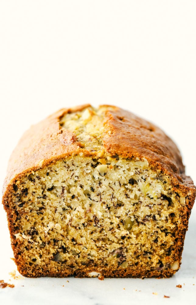 Treat yourself with a slice of thick, rich, and moist banana bread. This is the easiest way to make it! It's full of flavor and always a hit with the family. Front view of a loaf of banana bread.