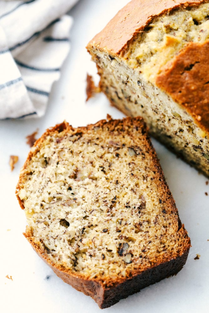 Treat yourself with a slice of thick, rich, and moist banana bread. This is the easiest way to make it! It's full of flavor and always a hit with the family. Closeup of a slice of banana bread.
