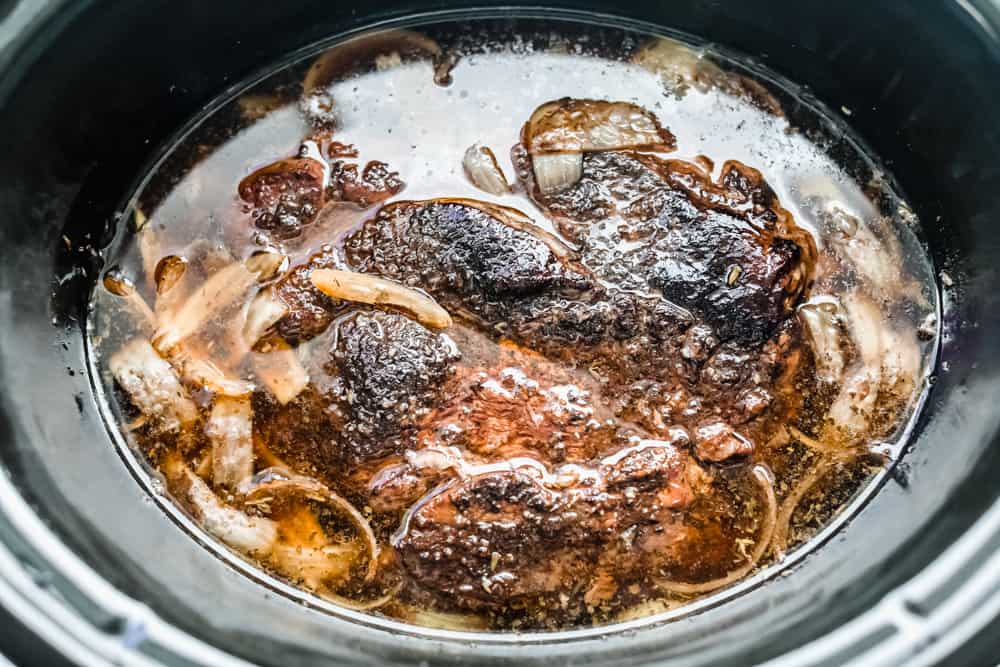 Slow Cooker French Dip Sandwiches are filled with tender chunks of roast beef with thin slices of melted mozzarella cheese all held together by a soft hoagie bread all dipped in au jus sauce. This warm, savory and comforting sandwich is a MUST! slow cooker beef