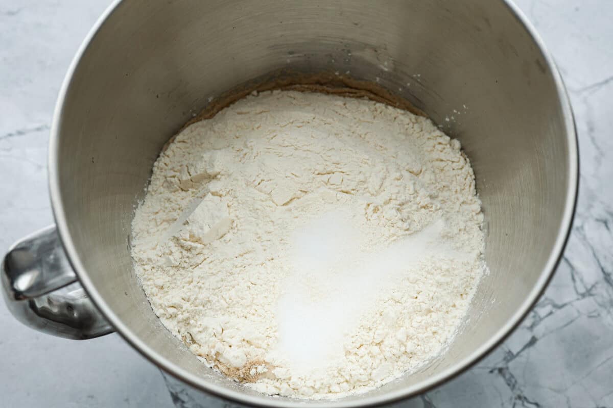 Homemade breadtwists have all the delicious buttery, garlic flavor of your favorite restaurant-quality breadsticks, but now they are unbelievably easy to make at home!ย The smell that fills your home will make you want to eat them straight out of the oven! Overhead shot of dough ingredients in a mixing bowl.