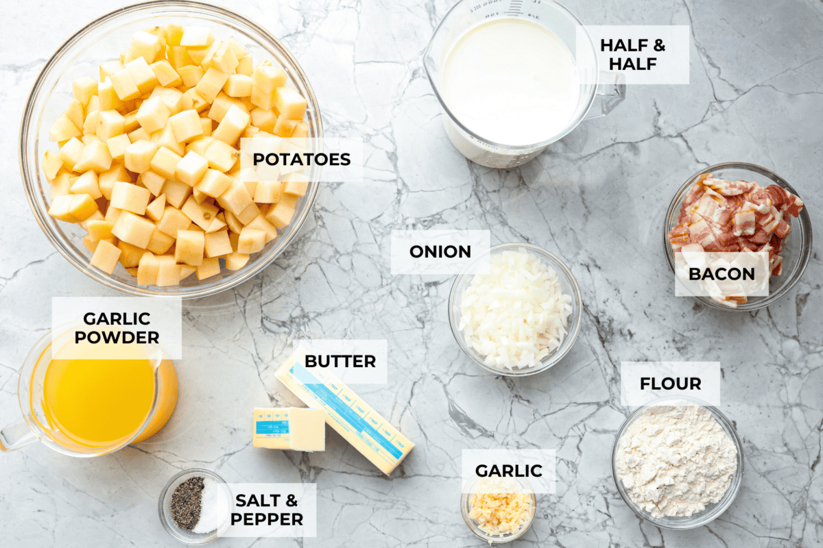 Creamy Potato Soup is the ultimate comfort food. It has a velvety, creamy base with blended potato, tender potato bites, onions, and garlic, all topped with crispy bacon! It's the perfect meal to cozy up with on a cold day. Overhead shot of labeled ingredients.