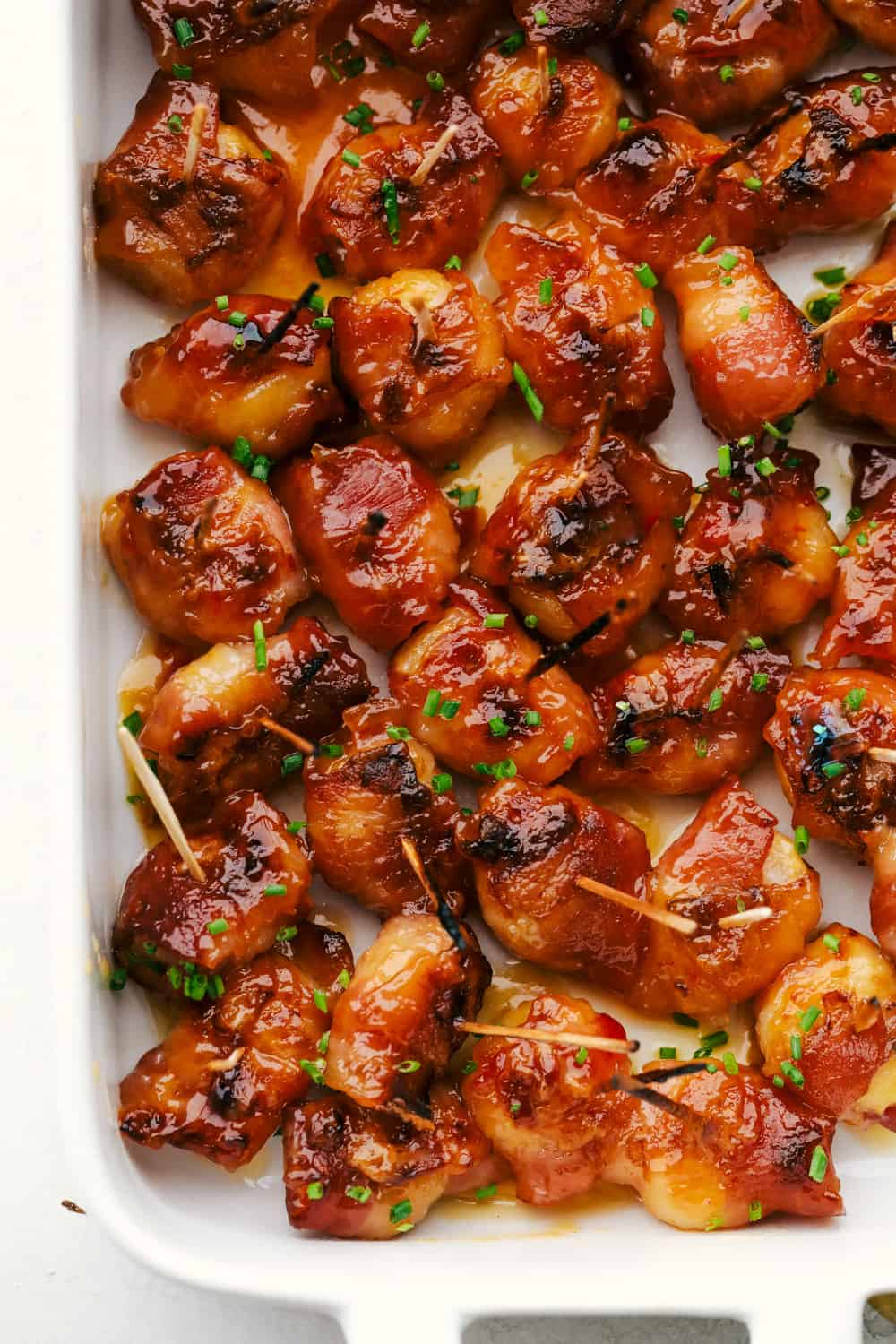 These Bacon Wrapped Chestnuts are crunchy sweet chestnuts, that are enveloped in a savory bacon and marinated in a sweet spicy sauce for the perfect flavor combination. Savory bacon wraps crunchy chestnuts in a sweet spicy sauce.