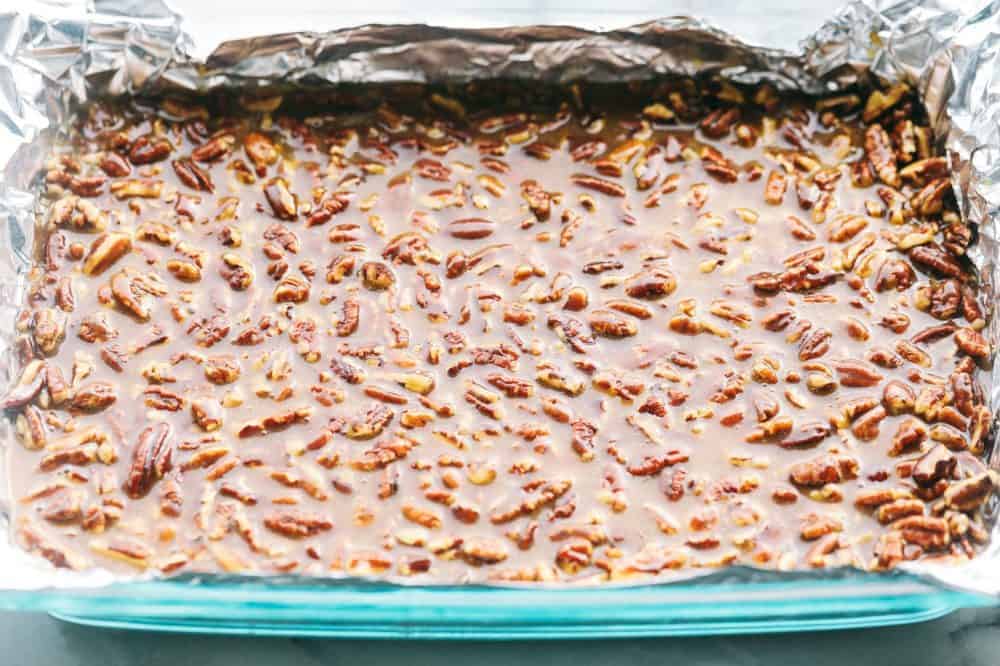 Best Ever Pecan Pie Bars takes the amazing pecan pie and transforms it into irresistible bars. A buttery shortbread crust that gets topped with a caramel pecan glaze, these are perfect for feeding a crowd! Pecan Pie Bars prior to being cut.