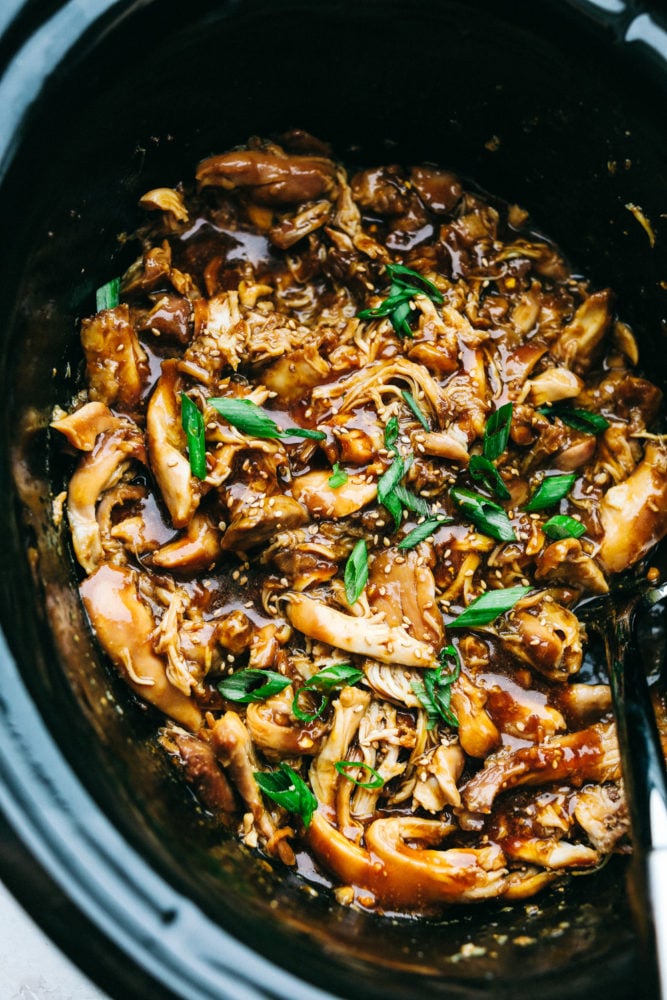 Slow Cooker Teriyaki Chicken is a simple saucy, sweet and tangy chicken served over tender long grain rice that truly satisfies. The aroma that will fill your kitchen will make your mouth water all day, the hardest part of this will be waiting till it's done. It's so simple and so flavorful, it'll become a standard in your recipe rotation. Slow Cooker Teriyaki Chicken in sauce in Crockpot.