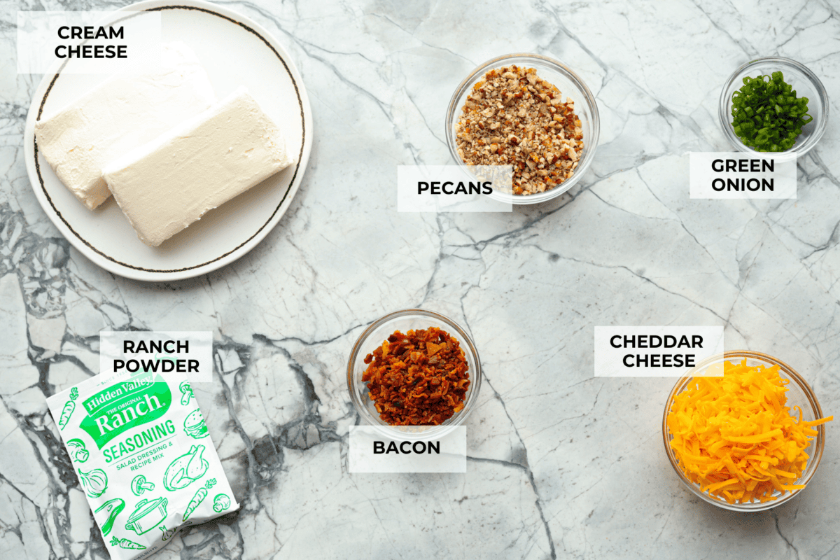 This bacon ranch cheese ball will be your favorite go-to appetizer! The winning combination of bacon, ranch seasoning, and cheddar cheese really stands out in this tasty cheese ball. Serve with crackers and watch everyone devour it! Ingredients labeled to make bacon ranch cheese ball.