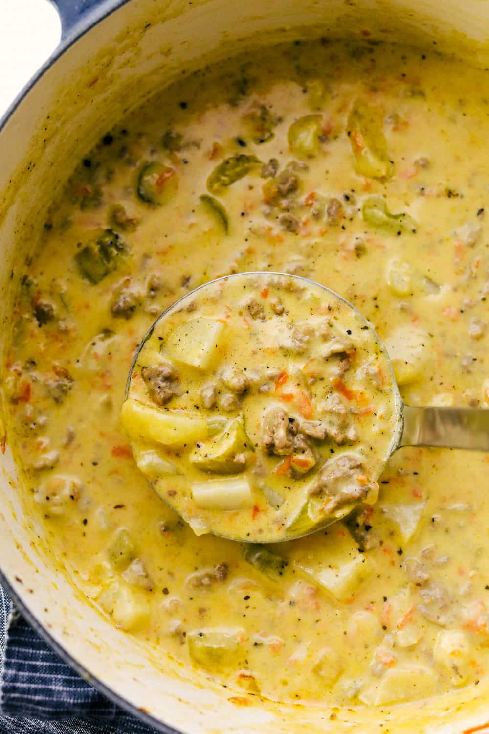 Award Winning Cheeseburger Soup is a thick and hearty soup with lean, tender ground beef, shredded carrots,ย dicedย celery and potatoes in a warm and creamy cheese soup. This is an award winning soup and it is excellent!ย Cheeseburger soup