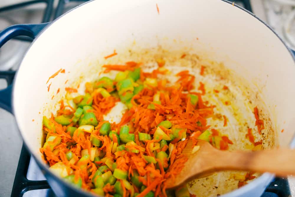 Award Winning Cheeseburger Soup is a thick and hearty soup with lean, tender ground beef, shredded carrots,ย dicedย celery and potatoes in a warm and creamy cheese soup. This is an award winning soup and it is excellent!ย vegetable being sautรฉed together in a pot over the stovetop.