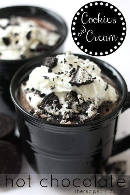 This cookies and cream hot chocolate drink is thick, rich and delicious! Warm up to this amazing beverage this winter season. Cookies and cream hot chocolate in black mugs topped with whipped cream and crushed Oreos.