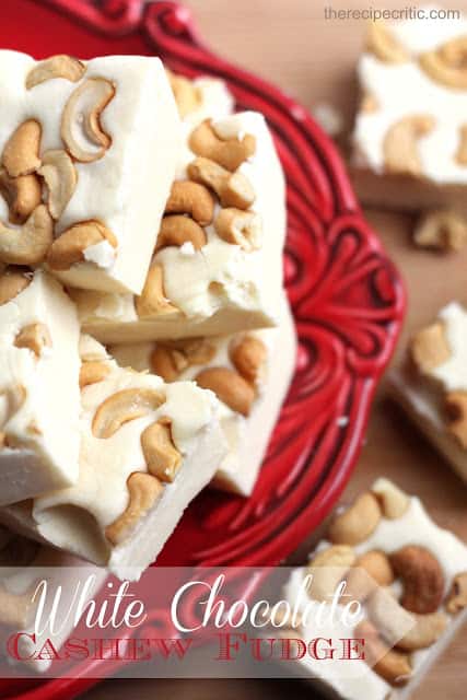 Making fudge was a lot easier than expected and I loved that it made a lot so that I can give it away for gifts. It was delicious! All of my favorite things in one fudgy yummy place! White chocolate cashew fudge stacked on top of each other on a red plate.