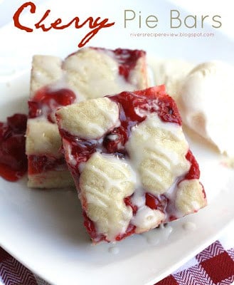 I have always been a cherry pie lover so these cherry pie bars became a favorite! Topped with a scoop of ice cream, this was a perfect treat! 2 cherry Pie Bars on a white plate.