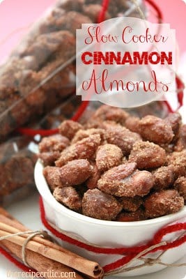 These slow cooker cinnamon almonds are so fantastic! I am so happy to know I can make them at home now! Slow cooker cinnamon almonds in a white bowl.