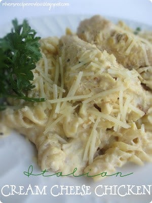 Ok this is a definite recipe that everyone needs in their house. It has been a favorite for YEARS. So easy to throw into the crockpot and absolutely delicious! Italian cream cheese chicken on a white plate with green garnish.