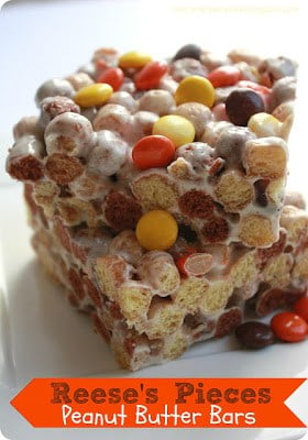 These were so easy to make and they were a fun twist on rice krispies. We love Reese's puff's cereal at our house! 2 Reese's Pieces Peanut Butter bars on a white plate.