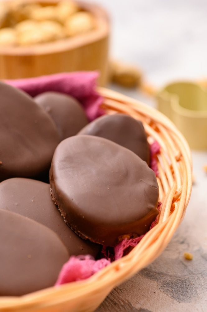 These homemade Reese's eggs are to die for!! With a creamy peanut butter center inside a thick, rich chocolate covering, these make the best Easter treat! A basket full of homemade Reese's peanut butter chocolate eggs.