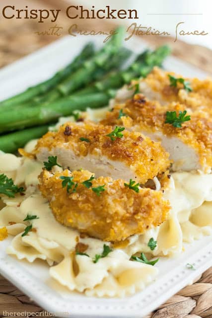 I served it with a side of fresh asparagus and it was perfection. This turned out to be such a great meal and I was even able to get my picky eater to eat 3 bites! That is huge progress! :) Crispy chicken with creamy italian sauce on a white plate with pasta and asparagus.