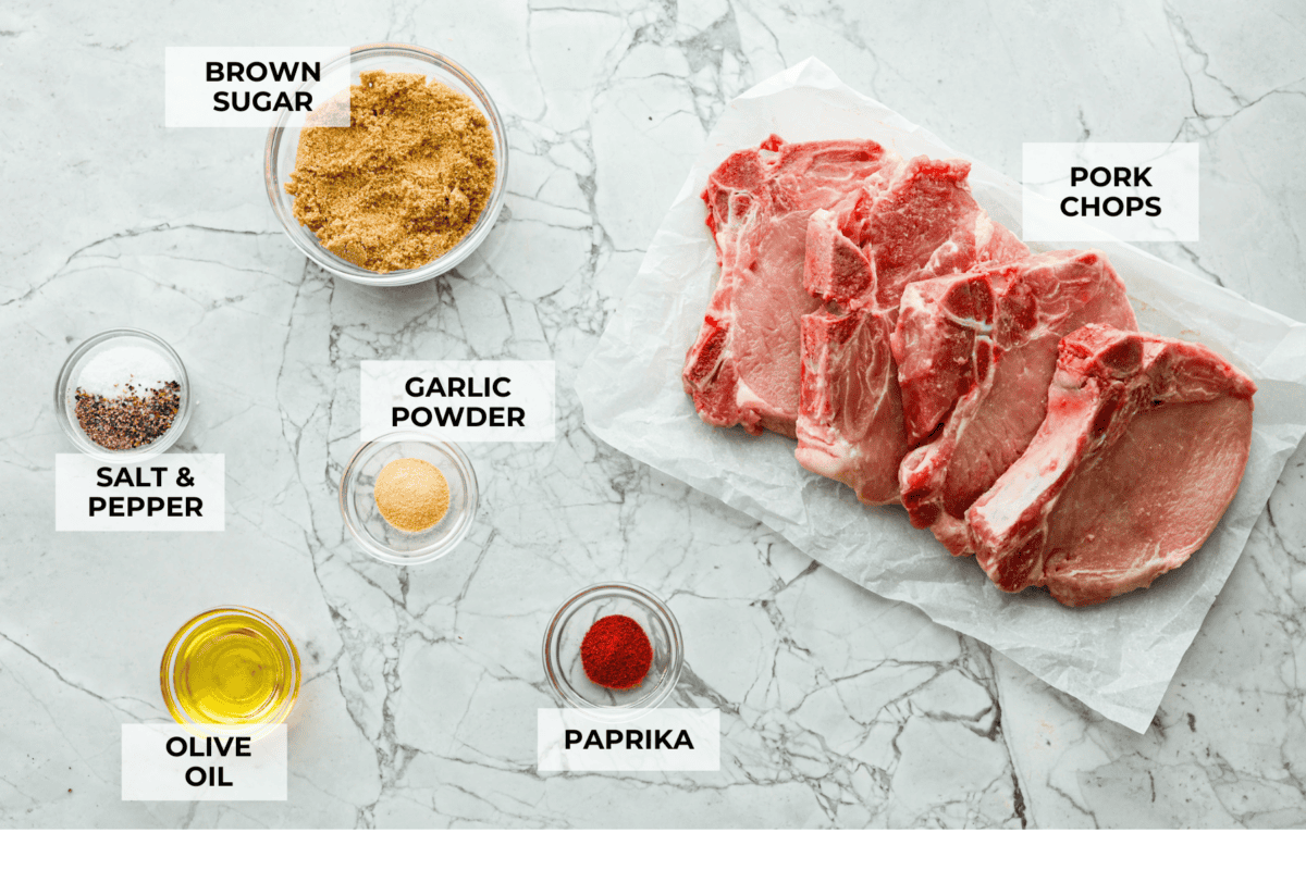 These brown sugar glazed pork chops are incredibly flavorful and delicious. Your family will love the salty pork smothered in a sweet brown sugar glaze. The crispy seared textured with the sweet sauce dripping down each bite will have you begging for more! Overhead shot of labeled ingredients.