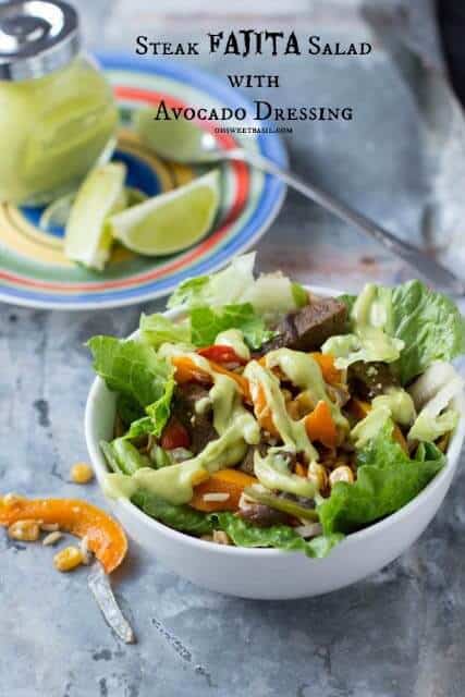 One of our favorite dinners that takes less than 30 minutes. Cheesy tortilla, fajita rice, sauteed peppers, onions and corn and avocado dressing Steak fajita salad with avacado dressing in a white bowl.