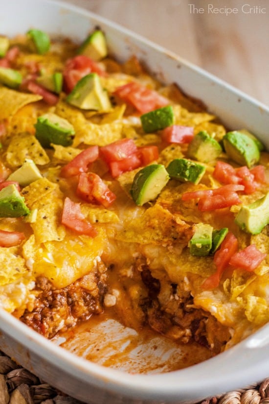 A delicious texas style casserole that can be spiced up with your favorite toppings! Texas casserole in a white baking dish with one piece missing to show the flavorful inside.