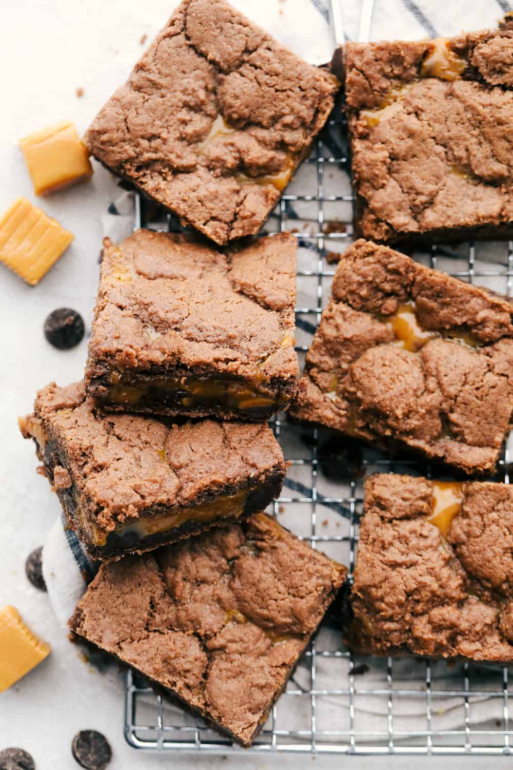Caramel brownies just got easier! Made with cake mix and melted caramel candies, they’re rich, gooey, egg-free, and fuss-free. This will be your new favorite shortcut dessert! Cooling caramel brownies on a cooling rack.