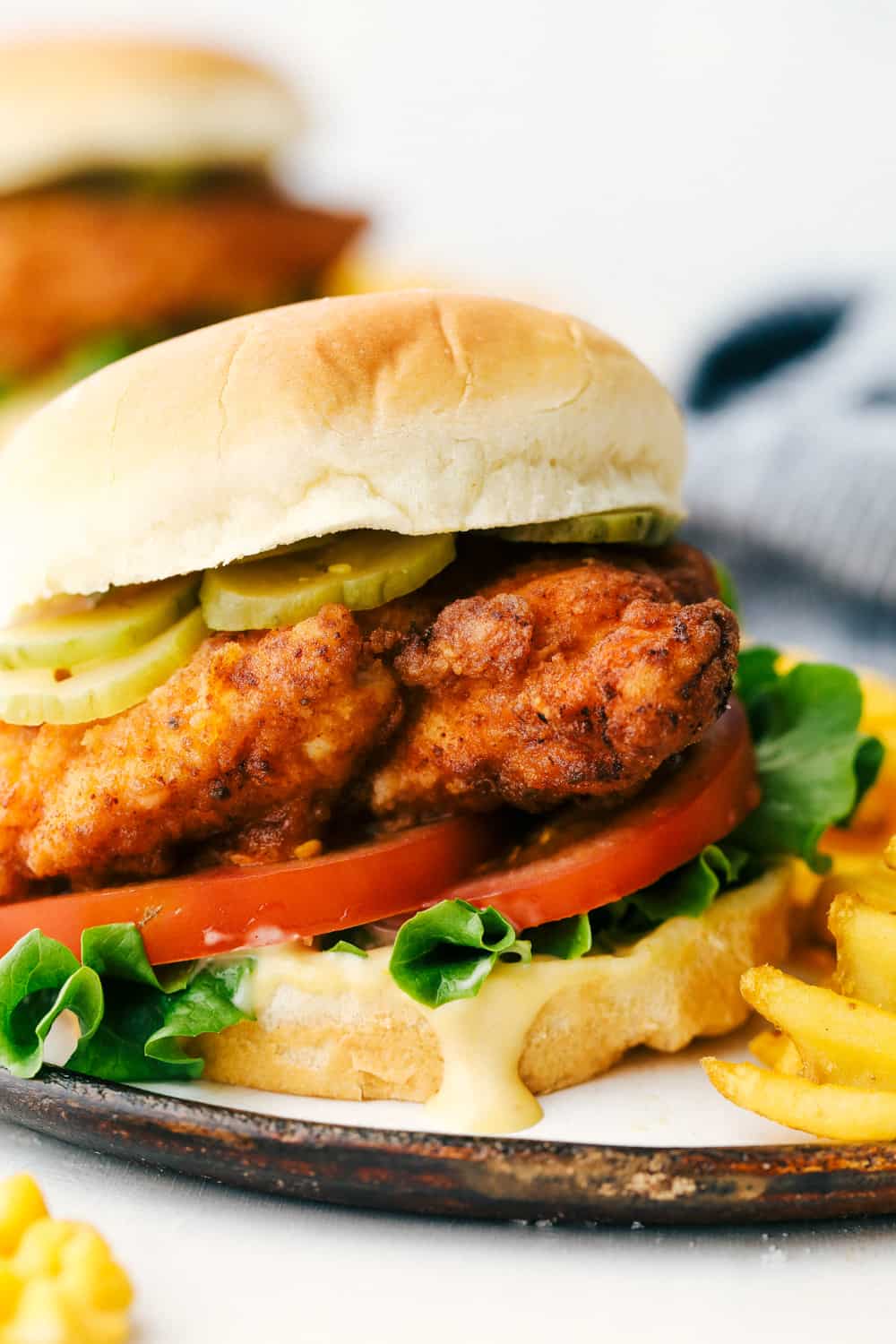 Chick-fil-A sandwiches are just as tender and juicy as the original, only better!ย Now you can satisfy your craving for those perfectly breaded and seasoned sandwiches anytime you need to! Copycat Chick-Fil-A Sandwich with fries on a plate.