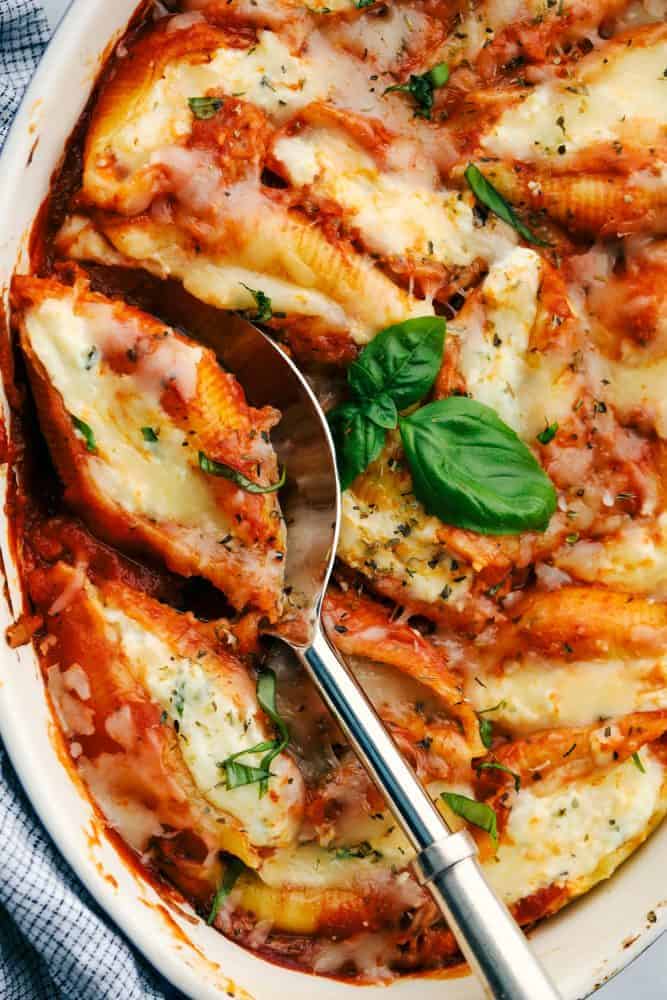 Three Cheese Stuffed Shellsย are a delicious twist on lasagna using jumbo shells that are stuffed with the classic lasagna cheese blend with Italian seasoning all baked in spaghetti sauce for a classicย Italian dish. A tried and true familyย favorite dinner! ย The best three cheese stuffed shells baked in a pan and easily served with a spoon.