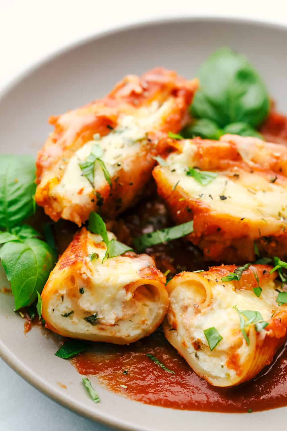 Three Cheese Stuffed Shellsย are a delicious twist on lasagna using jumbo shells that are stuffed with the classic lasagna cheese blend with Italian seasoning all baked in spaghetti sauce for a classicย Italian dish. A tried and true familyย favorite dinner! ย The best three cheese stuffed pasta shells recipe on a plate by The Recipe Critic