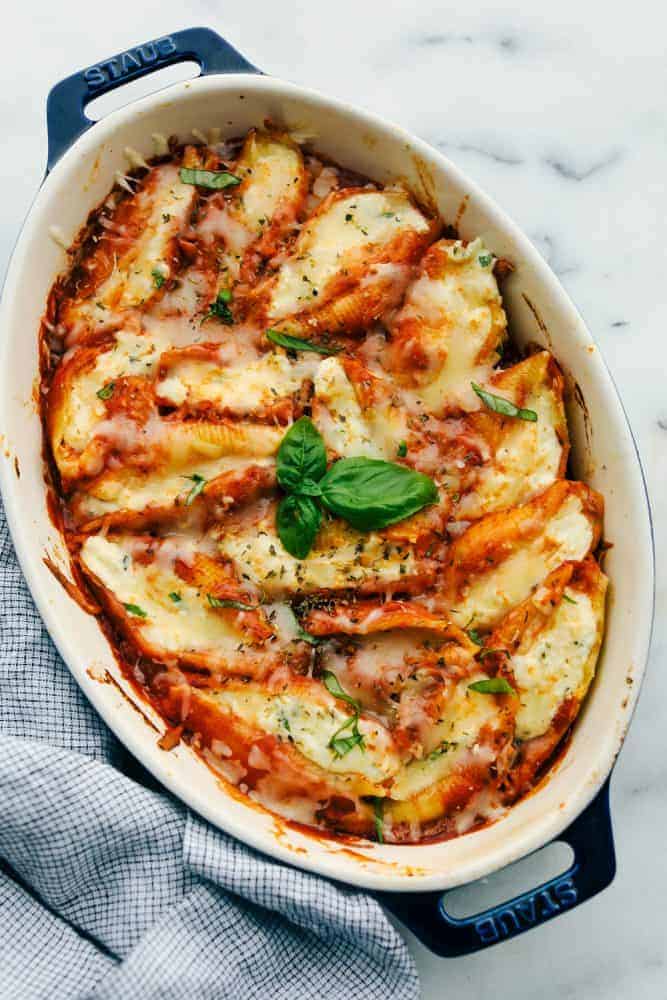 Three Cheese Stuffed Shellsย are a delicious twist on lasagna using jumbo shells that are stuffed with the classic lasagna cheese blend with Italian seasoning all baked in spaghetti sauce for a classicย Italian dish. A tried and true familyย favorite dinner! ย Easy three cheese stuffed shells baked in a pan to enjoy by The Recipe Critic