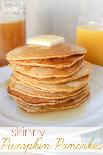 Delicious Pumpkin Pancakes made with healthier ingredients! Stack of skinny pumpkin pancakes in a stack on a white plate.