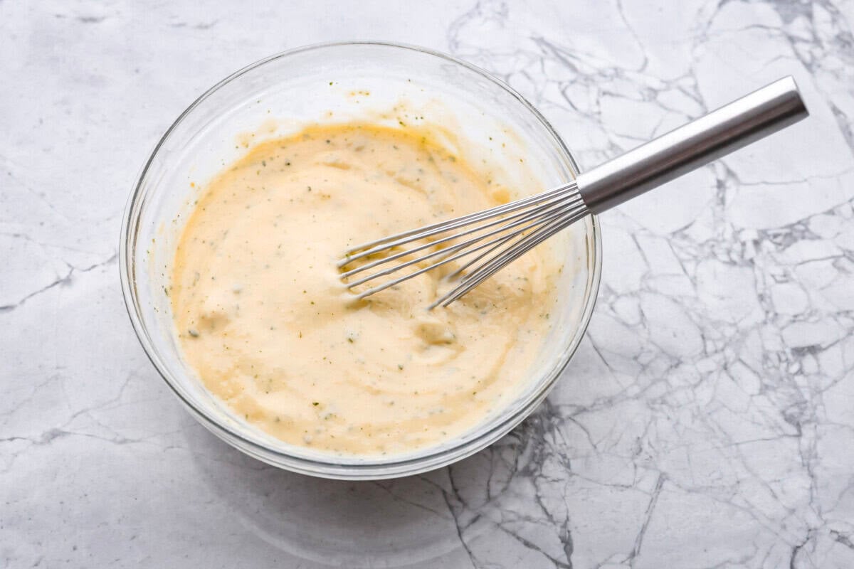 My Slow Cooker Creamy Ranch Chicken takes 10 minutes of prep and uses 6 simple ingredients. It's so good your whole family is going to love it, even your picky eaters! Ranch seasoning, milk and soup whisked together in a bowl.