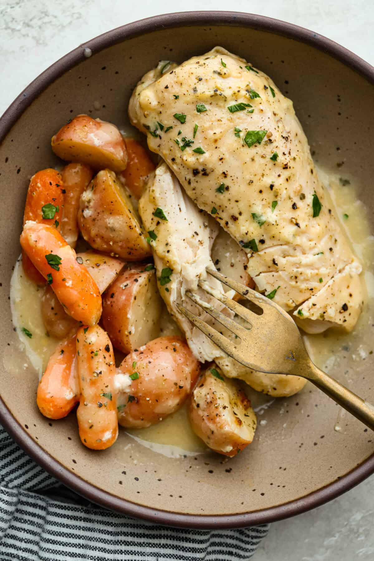 My Slow Cooker Creamy Ranch Chicken takes 10 minutes of prep and uses 6 simple ingredients. It's so good your whole family is going to love it, even your picky eaters! Plated slow cooker creamy ranch chicken.