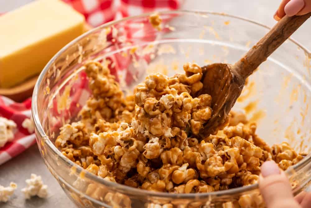 Amazing Salted Caramel Popcorn is a sweet and salty snack with melted caramel covering each popcorn for a soft, crunchy, rich and chewy snack! The Ultimate Sweet and Savory Snack! Amazing salted caramel popcorn in bowl