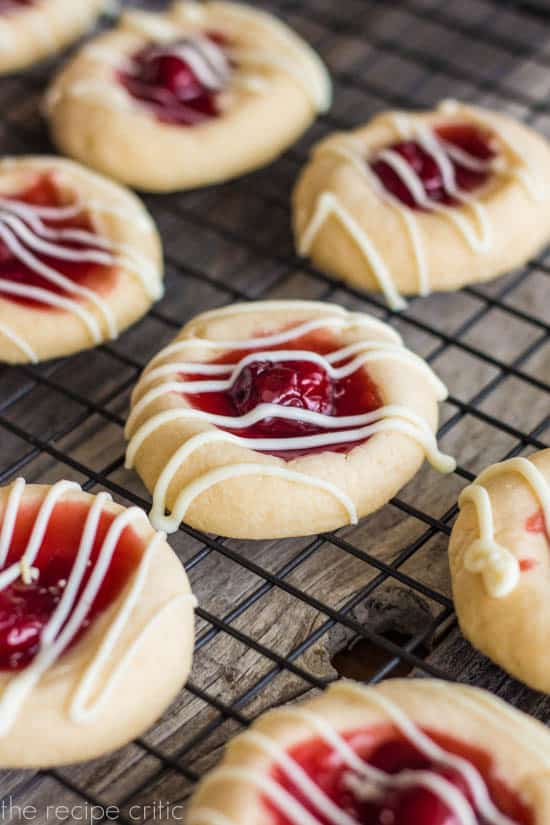 The cherry pie filling gave these cookies a bright and beautiful presentation. They looked fantastic and would be the first cookies to get eaten in a cookie exchange. They are fun, easy to bake and the perfect cookie! Cherry pie cookies on a cooling rack.