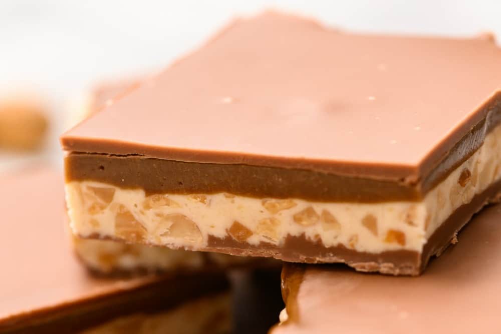 Who says you need to go to the store for a snickers, now you can make them at home whenever the craving hits! Homemade snickers bar close up.