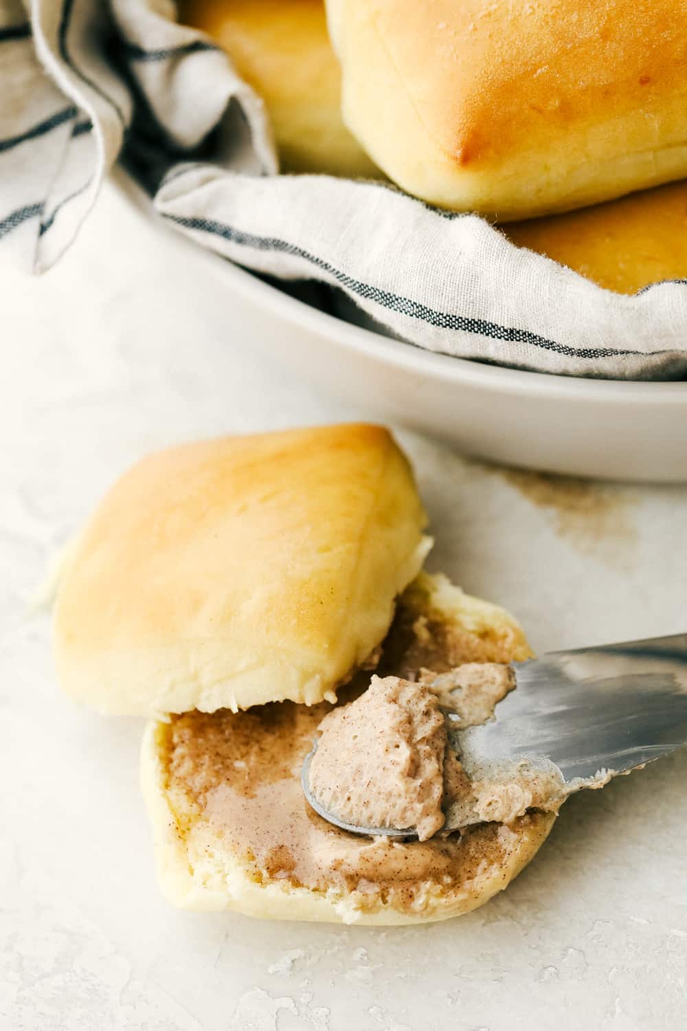 This cinnamon honey butter is rich, creamy and a smooth blend that is spreadable and ready in minutes. This is even better than Texas Roadhouse butter! Cinnamon honey butter spread over top Texas Roadhouse rolls.