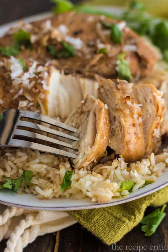 Slow cooker chicken with amazing flavor that the entire family will love! Coconut chicken bite on a fork.