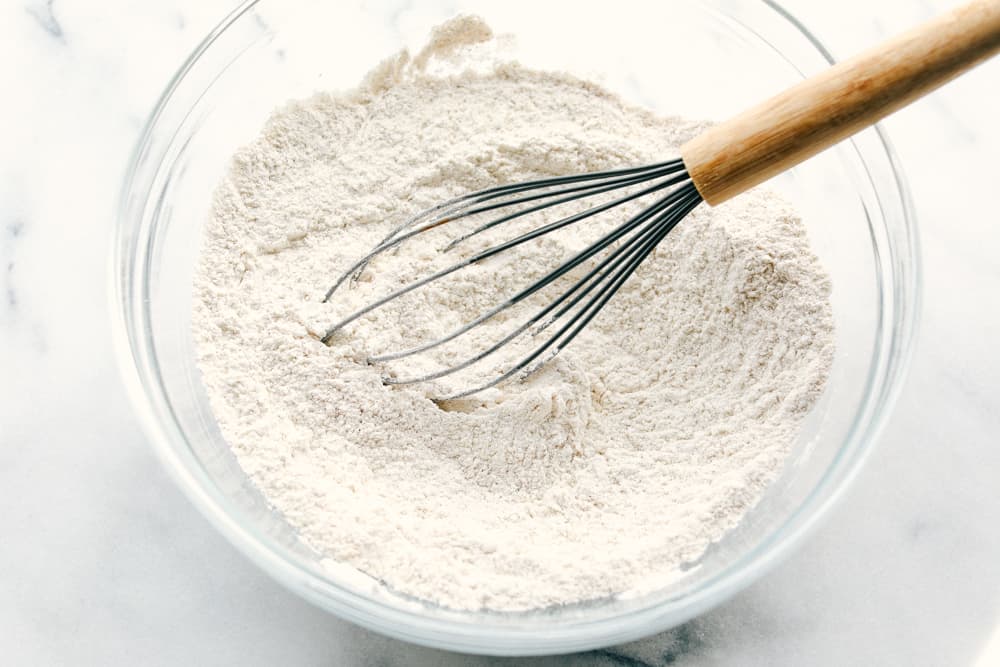 These banana pancakes are perfectly soft and fluffy and taste just like warm banana bread... in pancake form, of course! It's a great recipe to use when you have any over-ripe bananas! dry ingredients in a glass bowl being whisked together