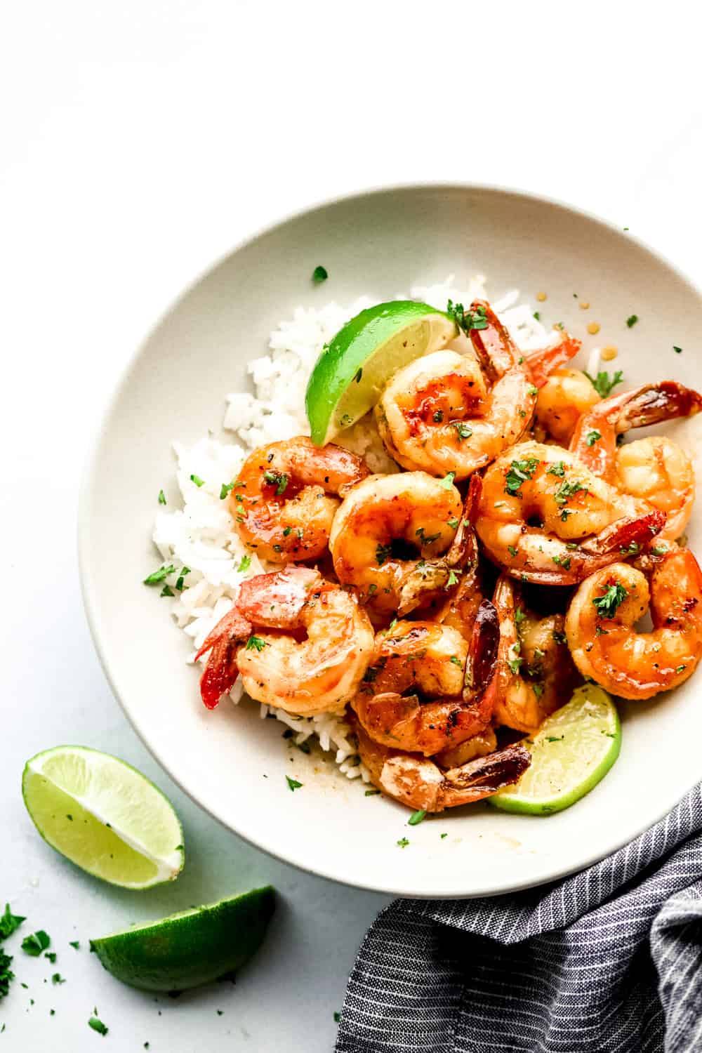 Honey Lime Shrimp is a delicious sweet and tangy shrimp that will be on your table in just 30 minutes! Simple and flavorful! honey lime shrimp over rice in a bowl