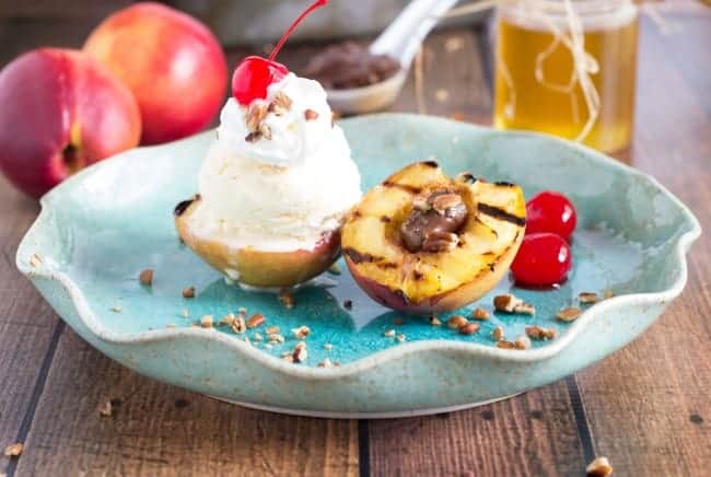 By grilling fruit, it brings out a lot of the natural sugars and sweetness in the fruit. Plus, the fruit part is still healthy. Totally a win โ win. Grilled Nectarine Sundae on a blue plate on a wooden table.