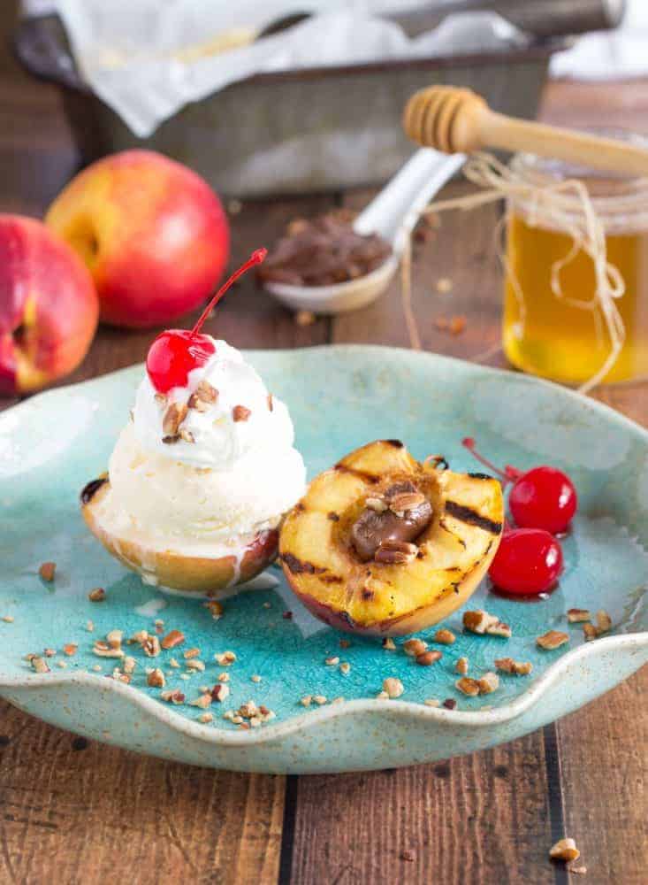 By grilling fruit, it brings out a lot of the natural sugars and sweetness in the fruit. Plus, the fruit part is still healthy. Totally a win โ win. Grilled Nectarine Sundae on a blue plate on a wooden table.