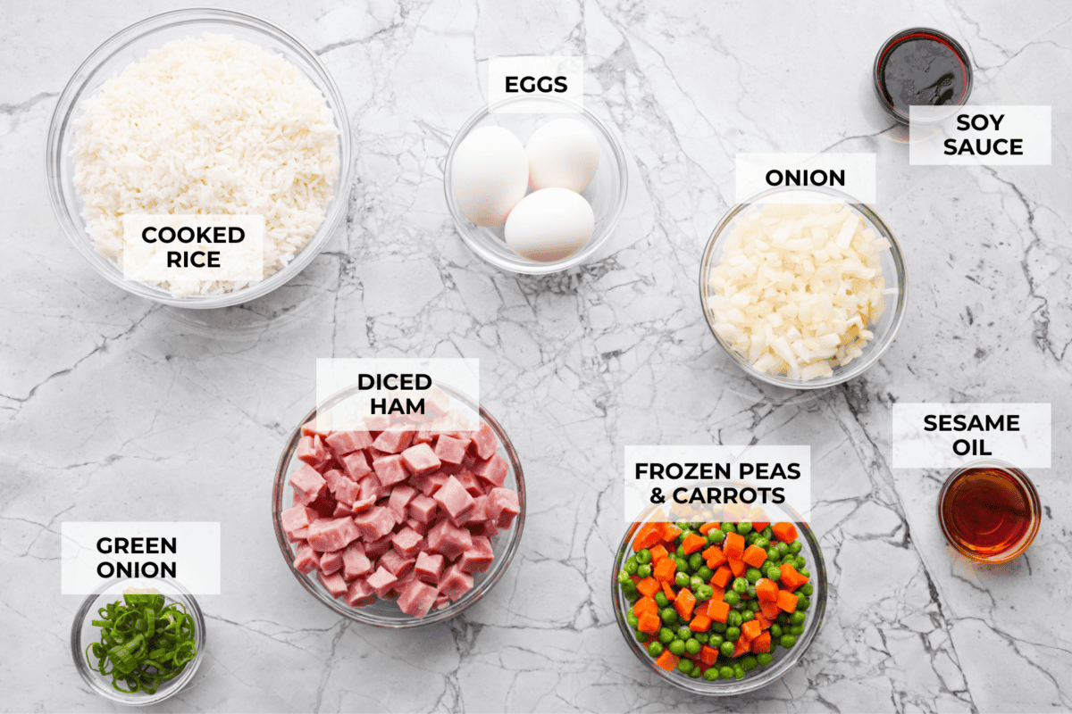 I know how much you guys love my fried rice recipes, and this Ham Fried Rice is a classic! Just toss in leftover rice, ham, and a few simple ingredients, itโs ready in under 30 minutes! Overhead shot of labeled ingredients.