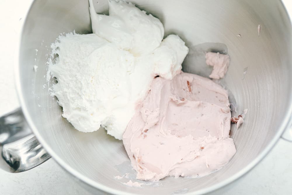 The best fruit dip that requires little effort and is absolutely fantastic! And it is only 2 ingredients! The ingredients of Strawberry Cream Cheese Fruit Dip in a KitchenAid mixing bowl.